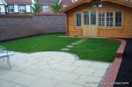 Garden was on a new development new Saxon paving with circle feature installed new lawn, stepping stones and low planter wall summer house with hot tub and lighting installed