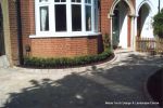 Driveway constructed using Tegula paving with sweeping curved path to front door and feature band across drive mouth, new wall, tier drop lawn and planting installed.