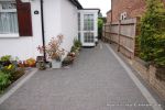 New driveway installed using granite paving with contrasting colour band and inset lights