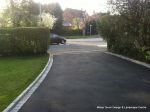 AFTER: Old tarmac removed original concrete base cleaned and re used with fresh tarmac overlay, drainage and edgings to create new tarmac drive