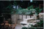 Sunken patio/dining area with natural Cotswold random stone retaining Walls with Integral BBQ and timber beams 