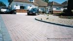Sweeping curved driveway installed with Marshalls Driveline 50 in brindle and Charcoal Kerbs