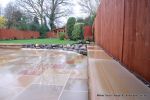 Tired garden received a complete new design Patio installed with 4 size sawn sandstone paving edged with firestone rocks and alpine planting, steps built with sawn sandstone uprights and sawn sandstone bullnose treads, New lawn installed in 3 rings all ed