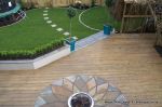 Soft wood decking with sandstone sunflower circle feature incorporated into the centre 