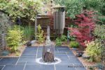 Town house garden paved with black limestone 