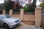 AFTER: Driveway was constructed with tumbled paver's in graphite grey, brick wall and pillars built using matching brick to property   