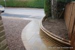 Sweeping sandstone path installed leading to front door, driveway perimeter edged with sandstone setts all hand pointed, Natural sandstone wall constructed with crease tile and 6mm Scottish beach gravel installed to 