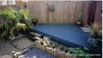 New deck installed and painted deep blue, gravel walkways with timber landscape poles and planting