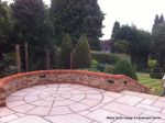 AFTER: Feature tumbled sandstone circle in cased with old stock brickwork with double bullnose on top