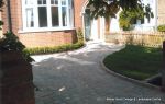 Driveway constructed using Tegula paving with sweeping curved path to front door and feature band across drive mouth, new wall, tier drop lawn and planting installed.