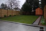 New Granite patio and path installed with contrasting dark colour band, New lawn, fencing and planting installed