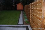 New Granite patio and path installed with contrasting dark colour band, New lawn, fencing and planting installed