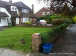 BEFORE: Driveway with old cracked concrete and mainly lawn with overgrown hedge