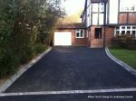 AFTER: Old tarmac removed original concrete base cleaned and re used with fresh tarmac overlay, drainage and edgings to create new tarmac drive