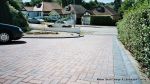 Sweeping curved driveway installed with Marshalls Driveline 50 in brindle and Charcoal Kerbs