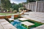 Sunken water feature inset in patio with stepping stones