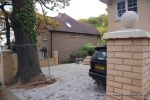 AFTER: Driveway was constructed with tumbled paver's in graphite grey, brick wall and pillars built using matching brick to property   