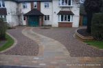 AFTER: Sweeping sandstone path installed leading to front door, driveway perimeter edged with sandstone setts all hand pointed, Natural sandstone wall constructed with crease tile and 6mm Scottish beach gravel installed to drive.