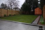 AFTER: New Granite patio and path installed with contrasting dark coulour band, New lawn, fencing and planting installed