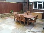 AFTER: Patio installed with 4 size sawn sandstone paving edged with firestone rocks and alpine planting, steps built with sawn sandstone uprights and sawn sandstone bullnose treads 