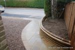 Sweeping sandstone path installed leading to front door, driveway perimeter edged with sandstone setts all hand pointed, Natural sandstone wall constructed with crease tile and 6mm Scottish beach gravel installed to drive
