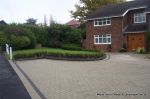 AFTER: New larger driveway constructed using pewter grey paving with contrasting colour band and feature curved double row of kerbs with Topiary hedge to retain level change.