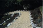 Access to children's play area built via a steep slope with Irish rockery, decorative gravel and sleepers ready for planting
