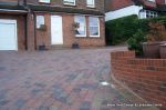 AFTER: Driveway installed with Tegula paving laid at 45 degree to property with in set lighting and feature wall merging into timber wall along front garden and road boundary