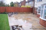 Tired garden received a complete new design Patio installed with 4 size sawn sandstone paving edged with firestone rocks and alpine planting, steps built with sawn sandstone uprights and sawn sandstone bullnose treads, New lawn installed in 3 rings all ed
